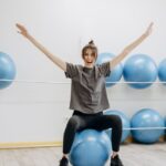 woman stretching on exercise ball