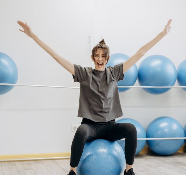 woman stretching on exercise ball