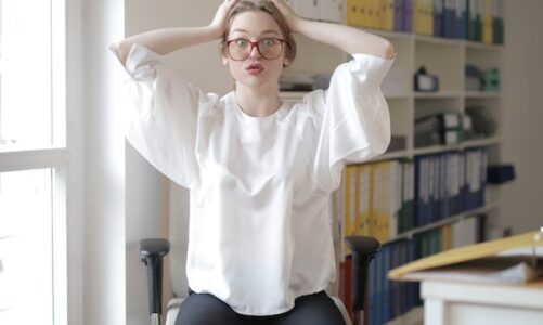woman at desk stretching