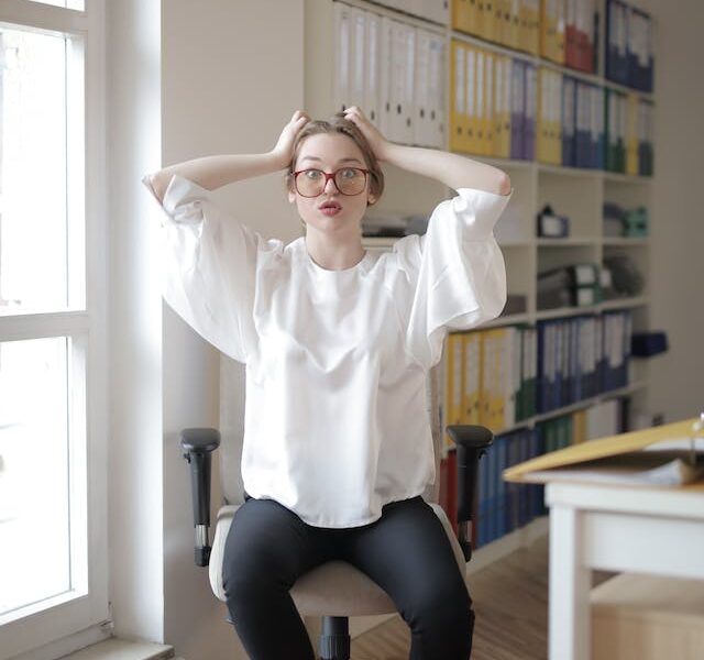 woman at desk stretching