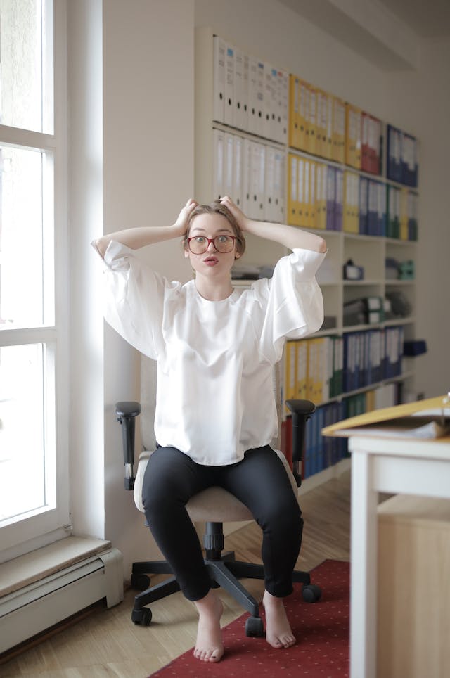 woman at desk stretching