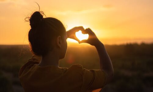 women making a heart with her hands