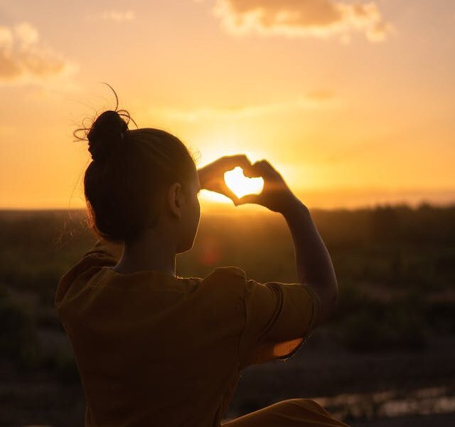women making a heart with her hands