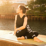 Woman in black clothing stretching