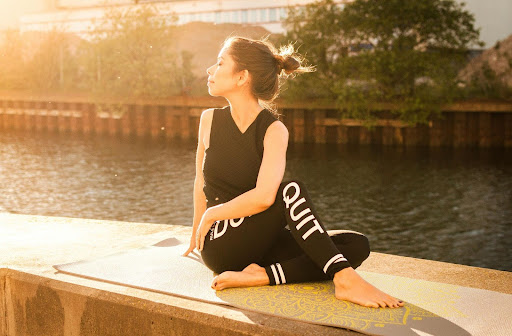 Woman in black clothing stretching